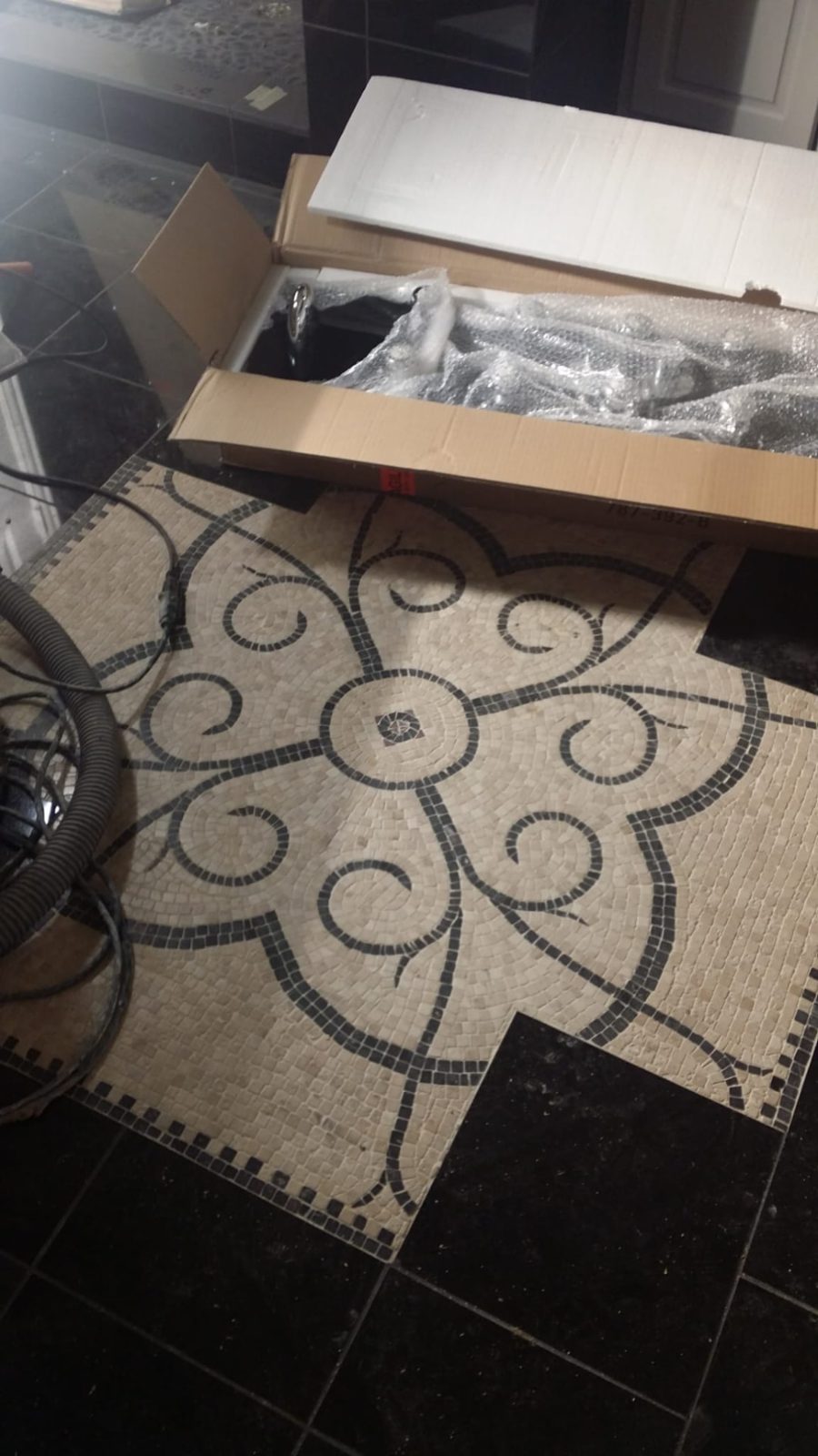 Custom stone mosaic floor medallion designed and set by Josh at 120 Buckingham Ln